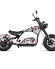 A chopper-style electric motorcycle with a black frame and seat, decorated with a white, red, and black graphic graffiti print, shown against a solid white background.